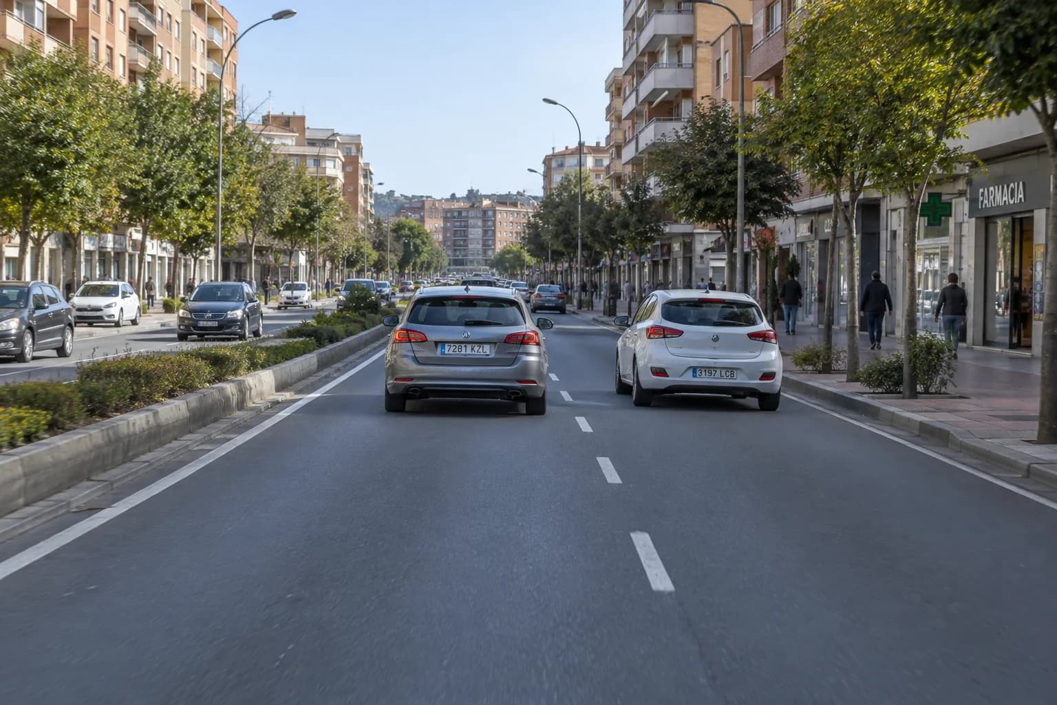 For a car without special restrictions, what is the general speed limit on the pictured urban road with two unrestricted lanes per direction and no specific speed signs?