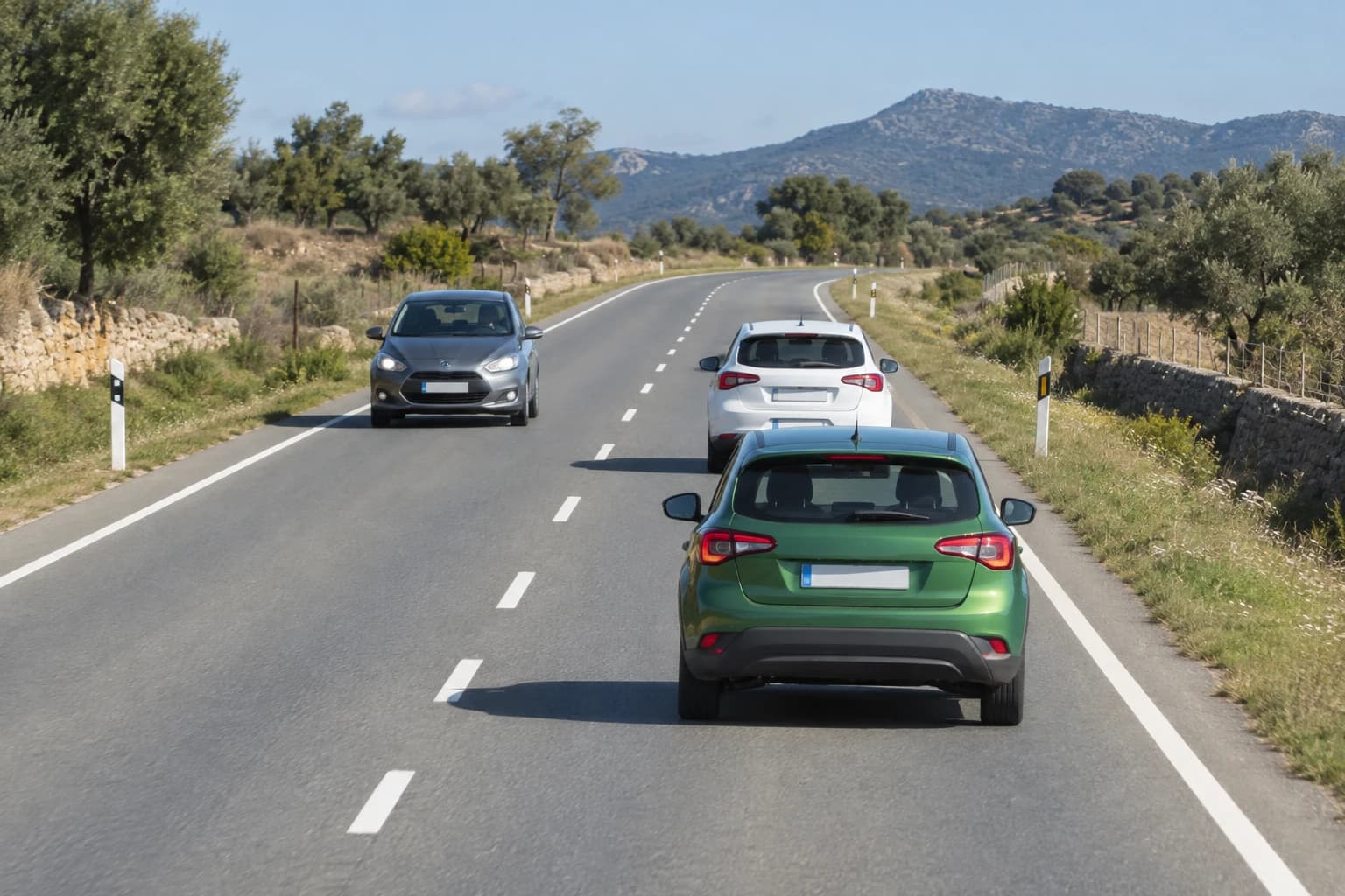 The green car would have to enter the opposing lane to overtake. The approaching vehicle is so close that it would have to brake or change course to avoid it. May the green car start overtaking?