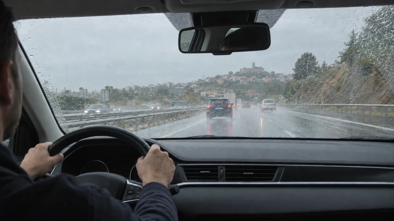 In a manual-transmission car with a mechanical handbrake, you are travelling straight on a wet surface and the service brake has become completely inoperative. What can help you stop?