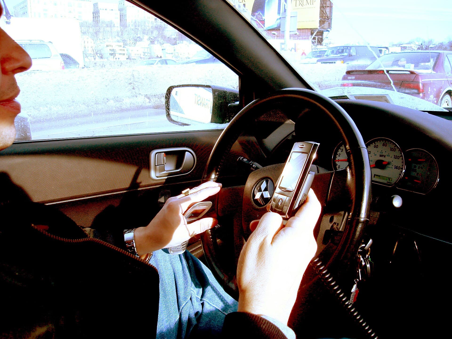Handling a mobile phone while driving an AM moped or light quadricycle: